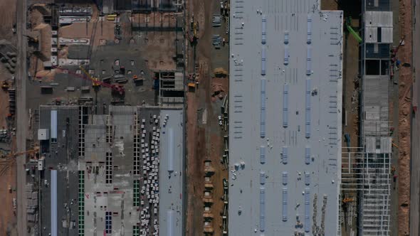 Generic Top View of a Big Construction Site with Building Structure and Heavy Machinery Equipment of alt