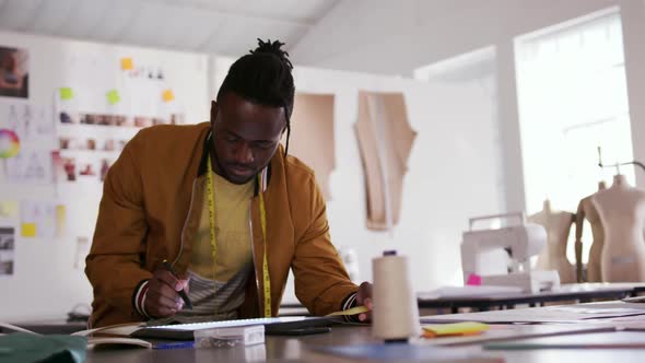 Mixed race man working in fashion office alt