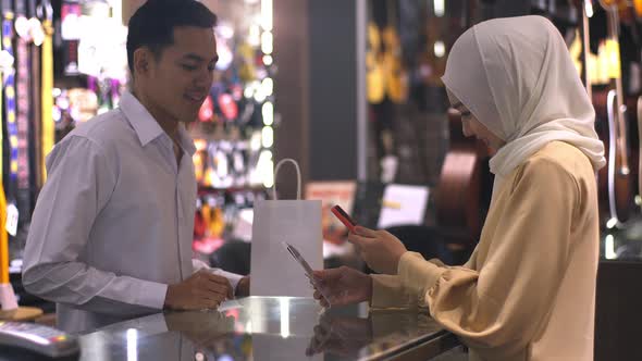 Asian Muslim Woman Using Mobile Phone To Scan QR Code 07