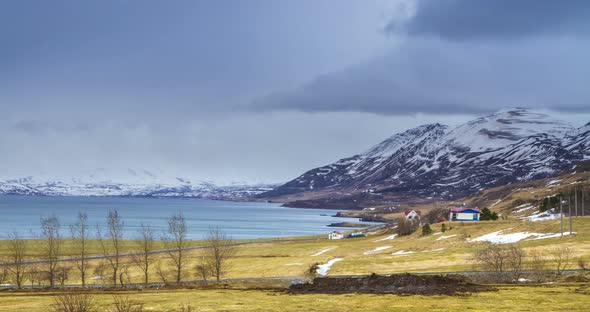 Cloud rolling time lapse over snow mountain fjords in Akureyri, Iceland. alt