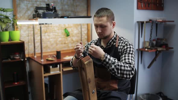 Leather Handbag Craftsman at Work in a Workshop