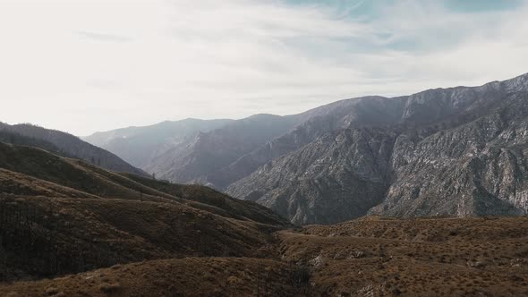 Drone camera moves over the mountains and shoots horizon in Sequoia National Park, California, USA alt