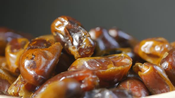 Super Close-up of Arb Dates Rotating. Only Dates and Gray Background. Healthy Food Concept. 