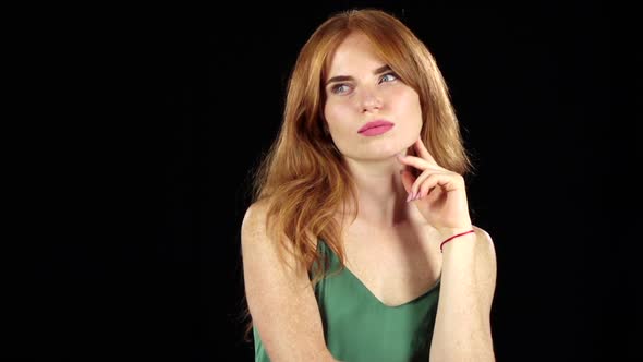 Girl Thinks About Her, and Finds the Answer To the Question. Black Background. Slow Motion alt