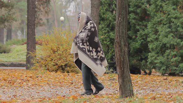 Lonely Poor Man Limping in Park, Strange Man Covered With Blanked Needs Help alt