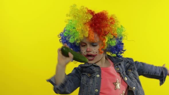 Little Child Girl Clown in Rainbow Wig Making Silly Faces, Singing, Smiling, Dancing. Halloween alt