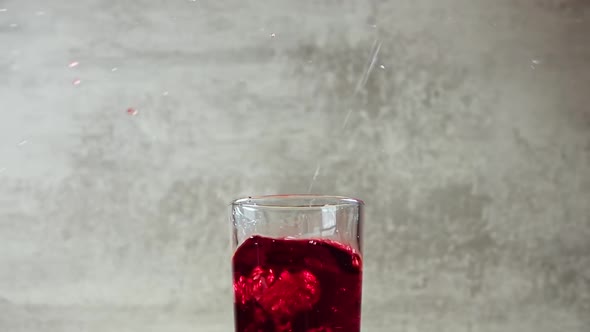 Ice Cubes Fall in Cherry Juice