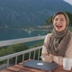 Fun Arab Young Muslim Woman in Hijab Laughing at Camera Sits Balcony Using Laptop Working Remote - VideoHive Item for Sale