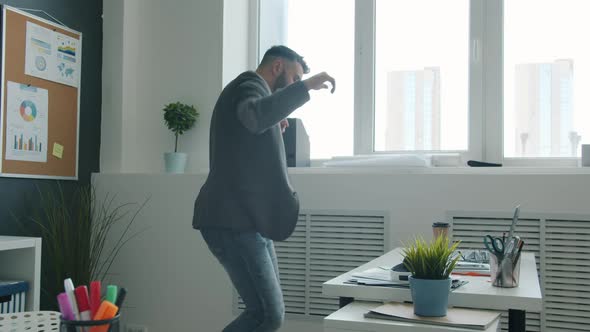 Slow Motion of Goodlooking Businessman Dancing and Having Fun in Modern Workplace alt