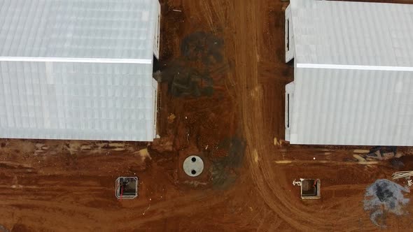 White buildings of new animal farm in the field. View from above on a new industrial complex. alt