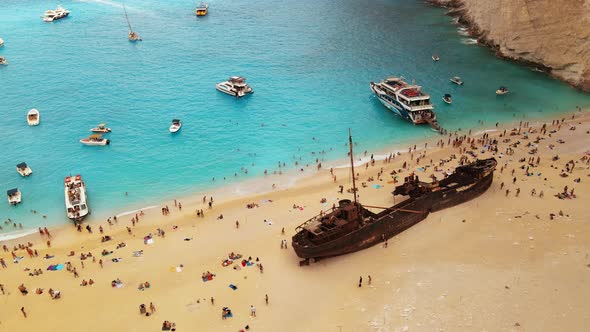 Aerial drone view of the Navagio beach on the Ionian Sea coast of Zakynthos, Greece. Moored boat alt