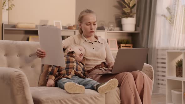 Mother Working Near Sleeping Son alt