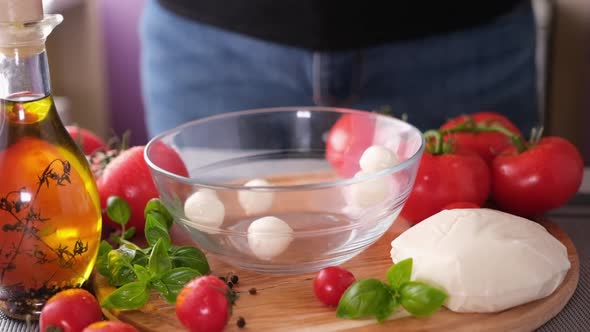Mozzarella Cheese Small Balls Falling Into Glass Bowl alt