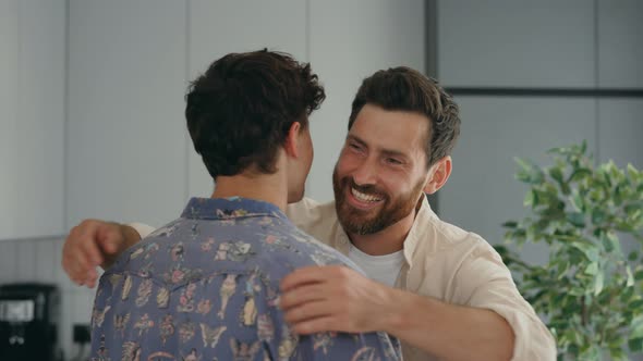 Close View of the Two Gay Mans Happy Hugging Together in Their New Apartment Feeling in Love with alt