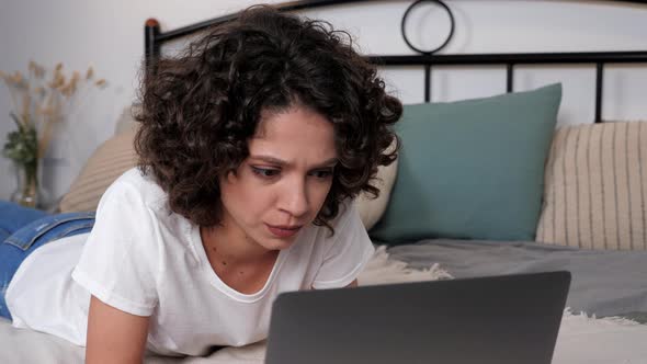 Focused Hispanic Curly Woman Student Study Uses Laptop Distance Education alt