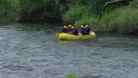 Group of people white water rafting celebrate
