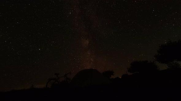 Bicycle And Tent Starry Night Timelapse alt