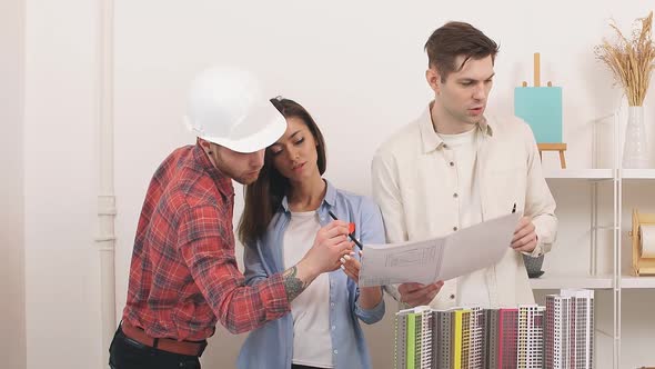 An Architect an Engineer and a Designer Discuss an Architectural Project for the Development of a alt