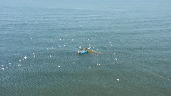 AERIAL: Fishermans Catching Fish in the Baltic Sea on a Sunny Bright Spring Day in Klaipeda alt