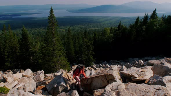 Young Woman Having an Adventure - Going on the Mountain with Backpack on Her Back alt
