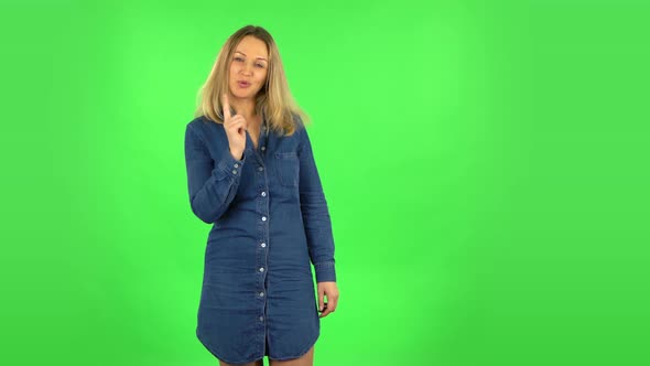 Fair Woman Is Seductively Smiling and Gesture Threatens By Shaking Her Index Finger, Green Screen alt