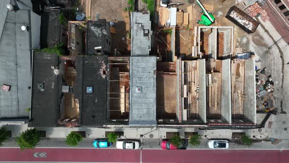Top down aerial of home without roof. Disrepair and crime in urban city setting. Abandoned rowhouses alt