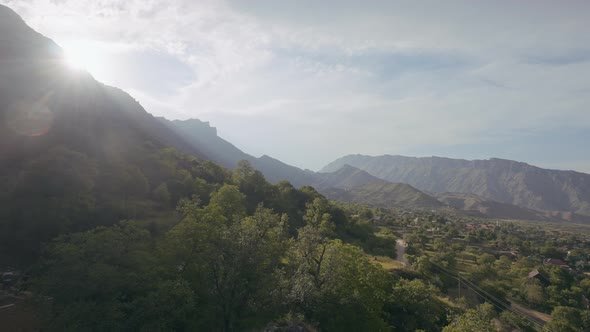 Flying above green slopes of rocks alt