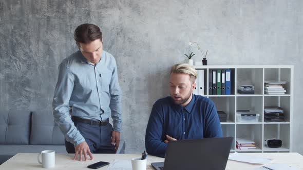 Two business persons are work together in modern office. Team of businessmen. alt