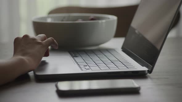 Close Up Pivoting Around Caucasian Woman Hand Swiping on Laptop Computer Touchpad While Code Review alt