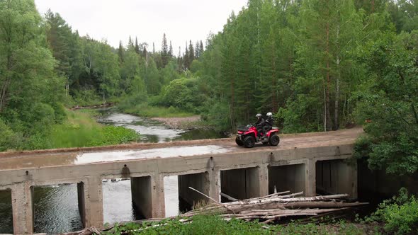 Drone Shot of People Driving Quad Bikes in Forest alt