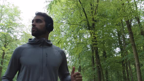 Handsome Athlete Jogging Through Forest