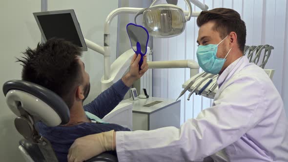 Patient Looks Into the Mirror at the Dentist's Office