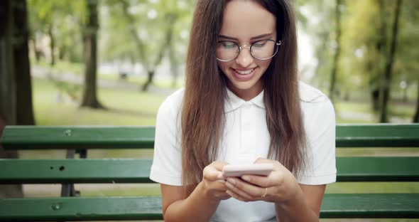 Woman Texting on Smartphone in Park