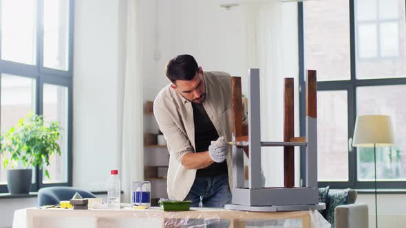 Man Painting Old Wooden Table in Grey Color alt