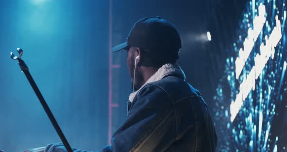 AfricanAmerican Man Dances While Playing an Electric Piano During a Concert alt