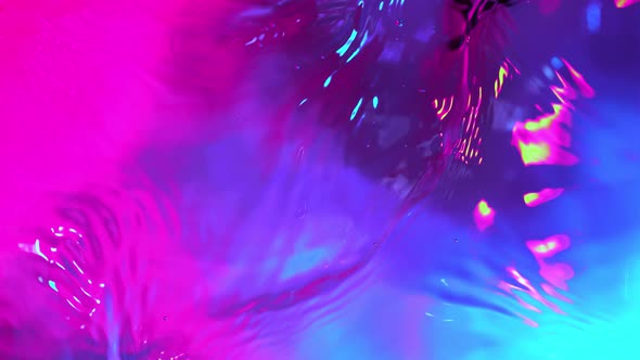 Super Slow Motion Abstract Shot of Swirling Neon Water at 1000Fps. alt