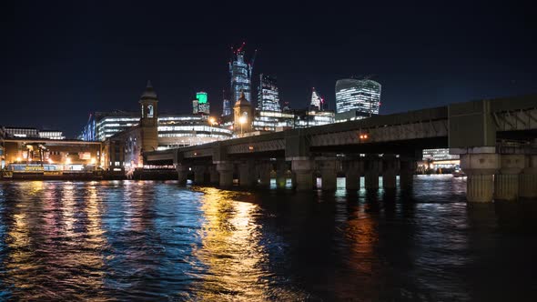Cannon Street Railway Bridge at night with City skyline in background, London, GB. alt