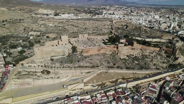 Impressive fortified citadel on hilltop - Almeria Alcazaba; drone arc alt