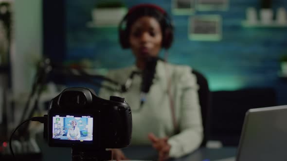 Close Up of Video Camera Recording African Influencer Talking Looking Into It alt