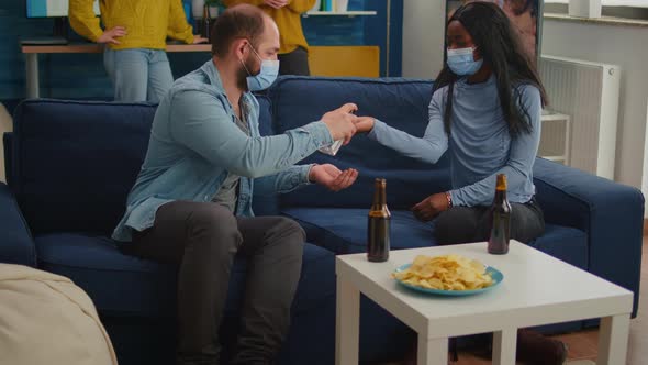 Group of Multi Ethnic Using Hand Sanitizer Gel to Prevent Covid19 Spread alt