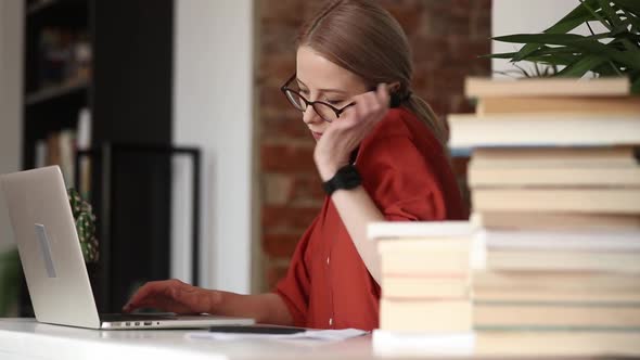 beautiful woman sitting at table and using a mobile phone in her home office alt