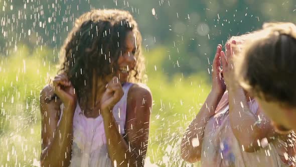 Two Laughing Young Women Get Splashed With Water at Color Festival, Slow Motion alt