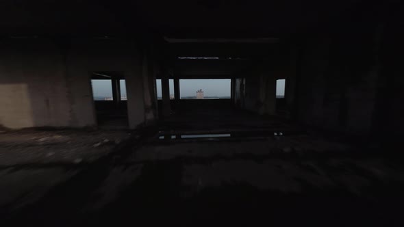 FPV Drone Quickly Flies Through an Abandoned Building and Moves Away From It alt