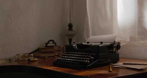 Old typewriter in front of an open window