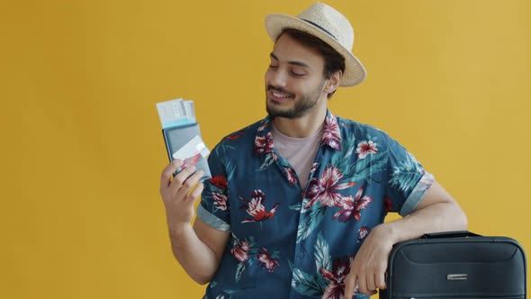 Slow Motion Portrait of Arab Tourist Holding Passport Travel Tickets and Credit Card Standing Near alt