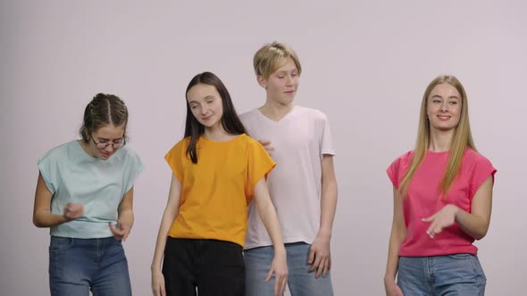 A Group of Cute Young People Looking at the Camera and Having Fun Dancing and Having Fun alt