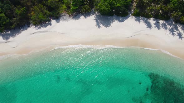 Aerial video beautiful closeup shot beach and seawater on crystal water wave on sand in sunset time alt