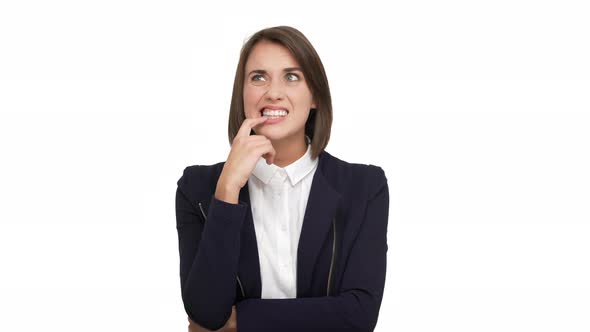 Portrait of Serious Concentrated Shorthaired Brunette 30s Touching Lips with Index Finger Thinking alt