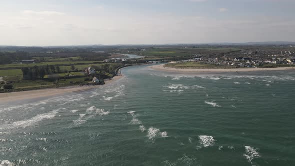 Drone shot of a small seaside town in Ireland on a sunny day. alt