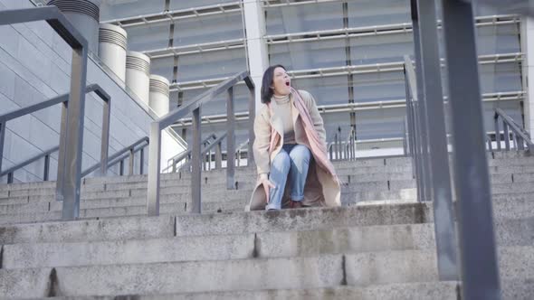 Portrait of Young Attractive Caucasian Woman Walking Down the Stairs When Having Sharp Ankle Pain alt